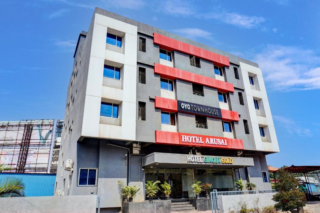 a building with red and white stripes on it at Hotel O Ginger Gold in Lohogaon