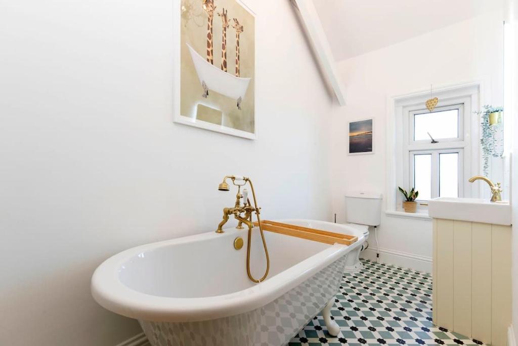a bathroom with a white tub and a sink at Spacious 3 Bed Apartment in central Saltburn in Saltburn-by-the-Sea