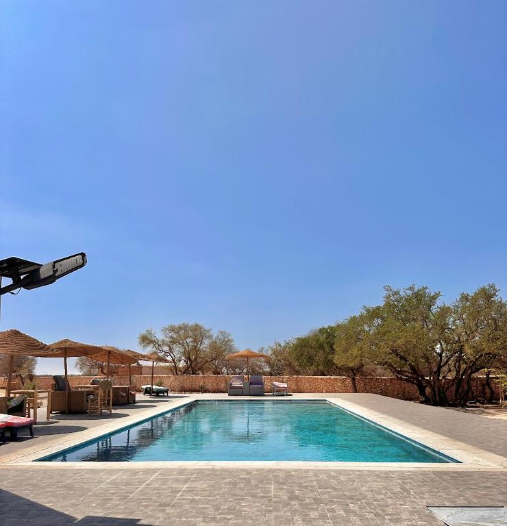 a swimming pool in the middle of a yard at Riad Maj Nia House in Essaouira