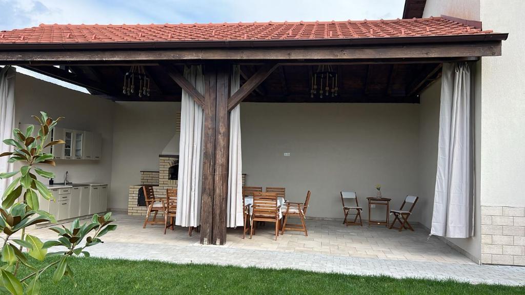 a pavilion with a table and chairs on a patio at Colt de Apuseni Guesthouse 