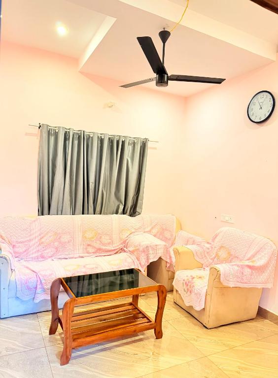 a living room with a couch and a table at Epic inn villa 3 bhk with kitchen Varkala cliff in Varkala
