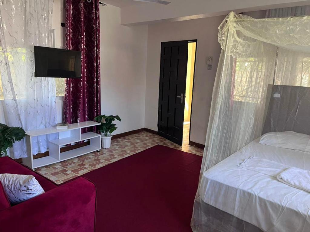 Ένα ή περισσότερα κρεβάτια σε δωμάτιο στο Round house beach apartment