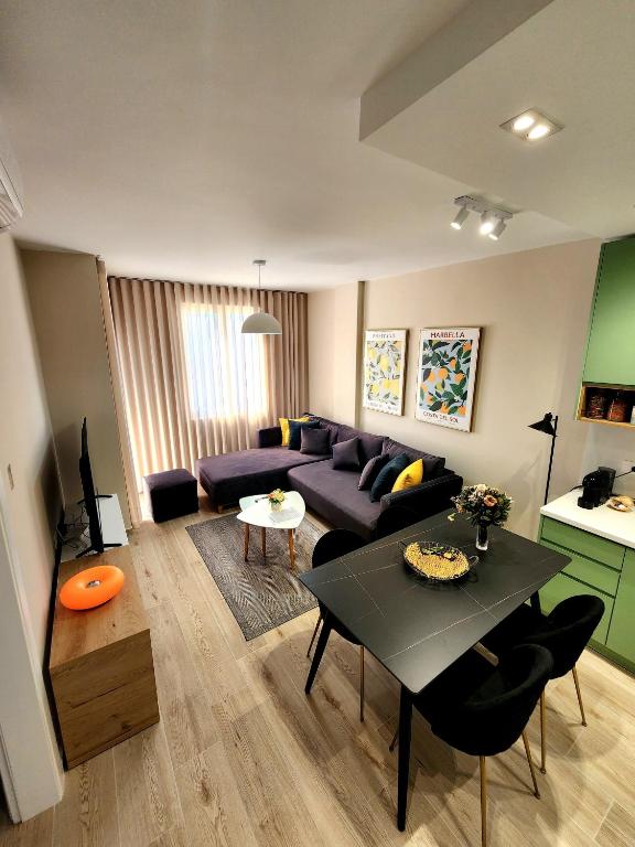 a living room with a couch and a table at Apollo Sea Apartment in Golem