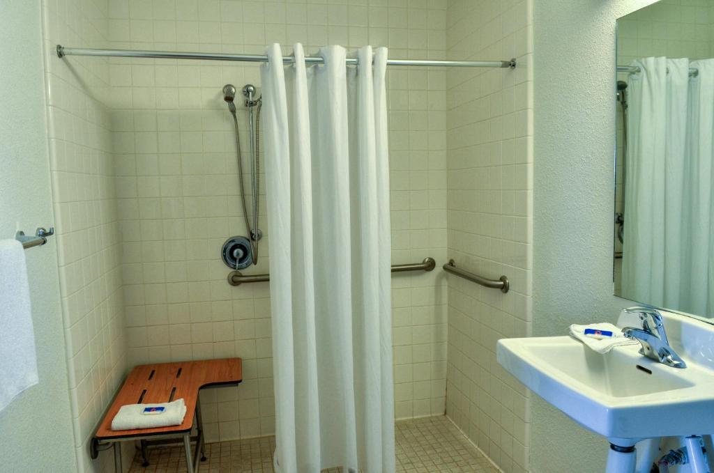 a bathroom with a shower curtain and a sink at Motel 6-Santa Nella, CA - Los Banos - Interstate 5 in Santa Nella