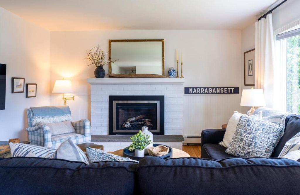 a living room with a couch and a fireplace at Beachwood of Narragansett in Narragansett