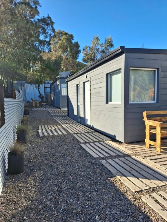 a tiny house parked next to a fence at Ecos de Mar Refugios in Puerto Pirámides