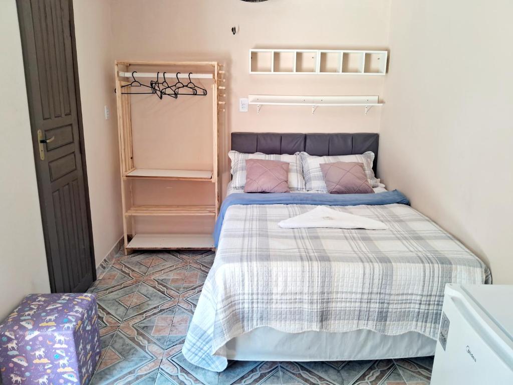 a small bedroom with a bed and a closet at Hospedagem Aconchego do Lar in Barreirinhas