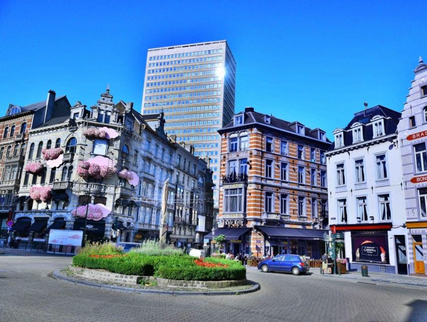 a city street with tall buildings and a car at Wonderful apartment in Sablon in Brussels