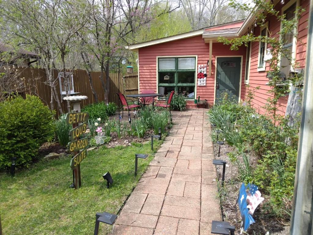 a backyard with a brick walkway in front of a house at Betty Lous Garden in Nashville