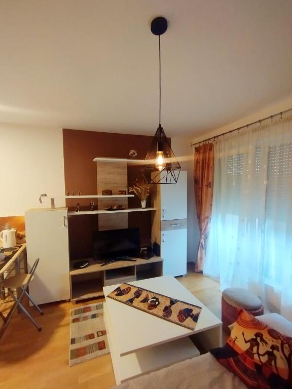 a living room with a couch and a table at Studio - Bee Happy in Sarajevo