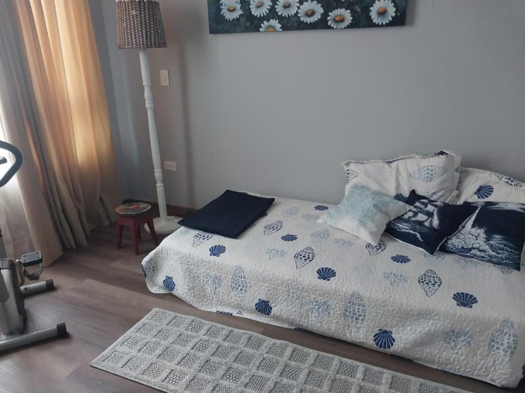 a bed with blue and white sheets and pillows at Bahía Fragata 204 in San Andrés