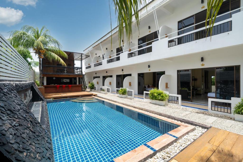an image of a swimming pool in front of a building at JR Siam Inn Resort in Kata Beach