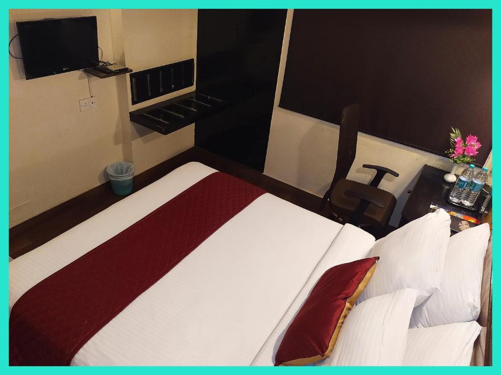 a hotel room with a bed and a television at HOTEL -THE R & HS PALACE - Near Sea Beach - Shree Jagarnath Temple - Free Wi-Fi Facilities # Fully Air Conditioned Hotel At Prime Location in Puri