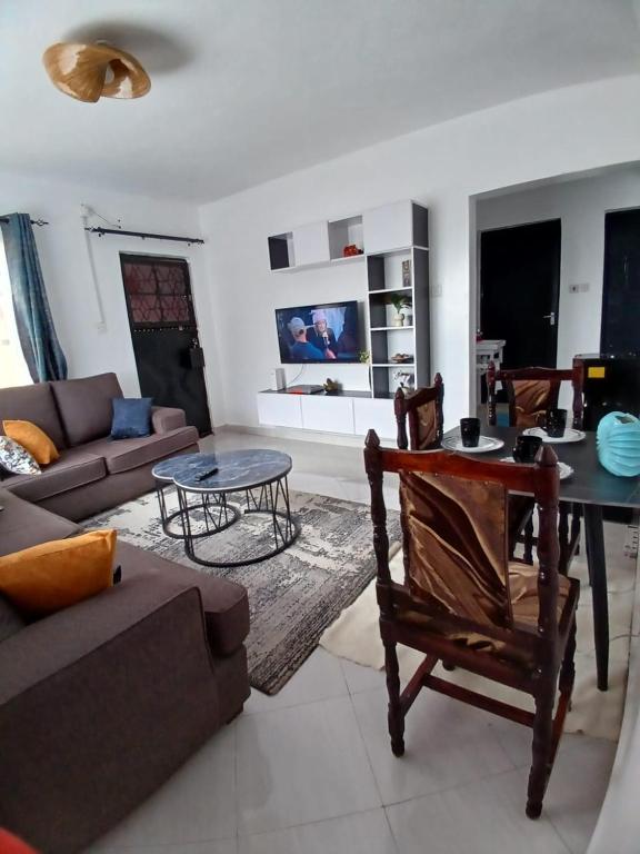 a living room with a couch and a table at Sere Cozy Home in Wundanyi