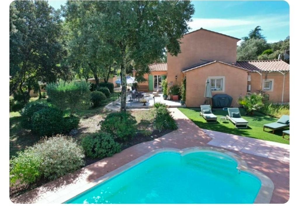 a swimming pool in the backyard of a house at Villa Rosalia in Uzès