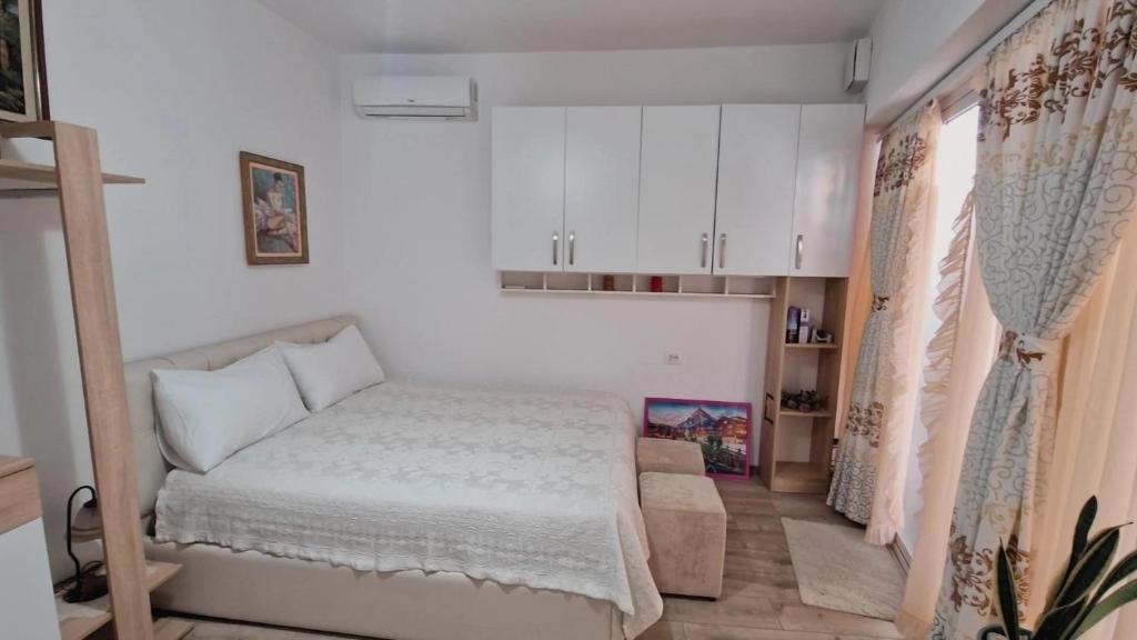 a small bedroom with a bed and a couch at City Center Room in Tirana