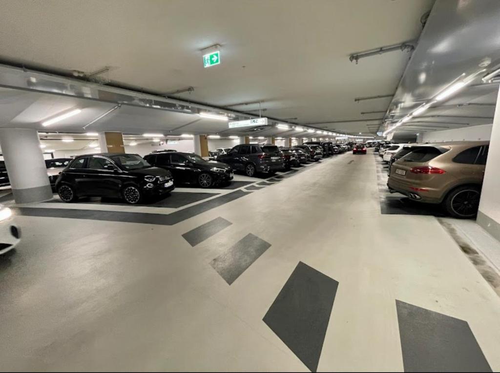 a parking garage filled with lots of parked cars at Exklusive 60qm Designerwohnung im Herzen von München - 1 min zur Maximilianstraße in Munich