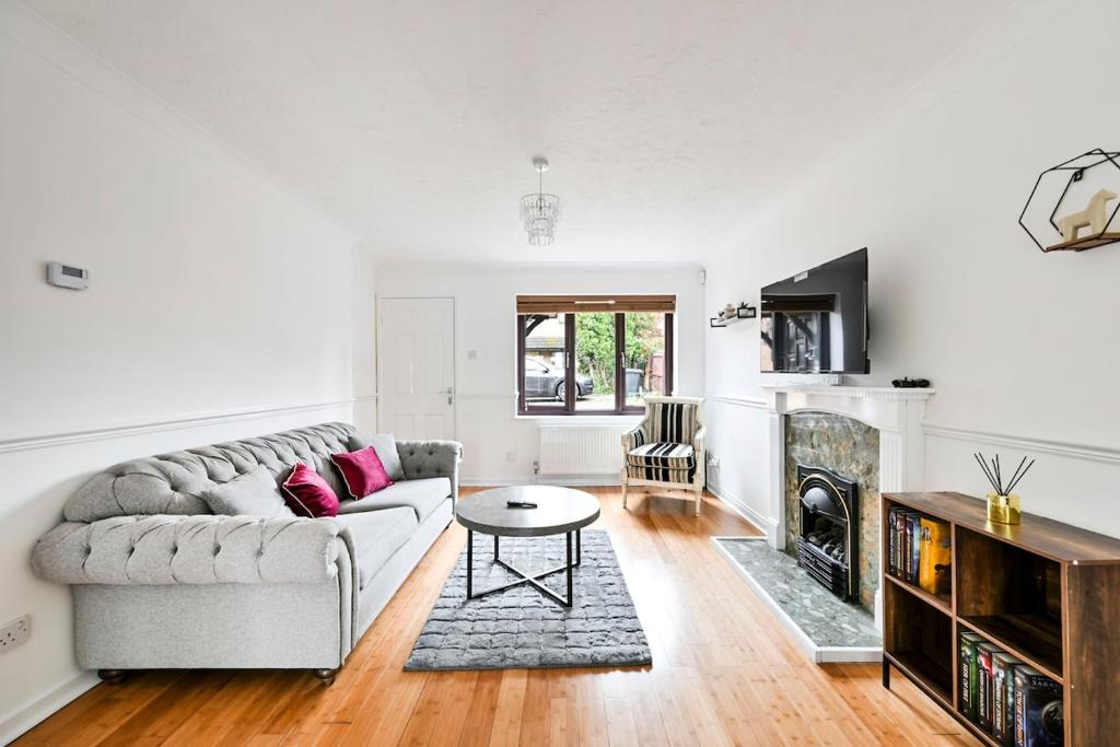 a living room with a couch and a table at Quiet & Modern Contemporary Home for Work & Family in Bedford