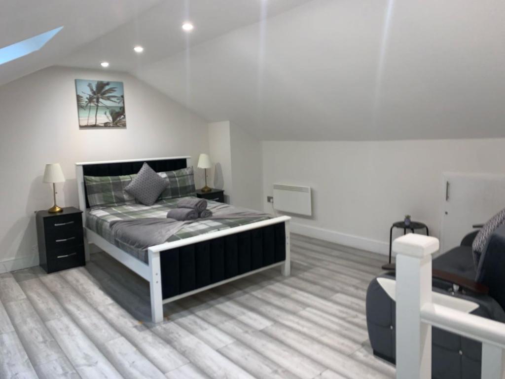 a bedroom with a bed in a white room at W5 Studio in Ealing