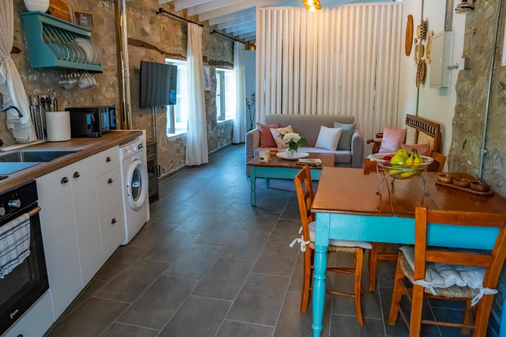 a kitchen and living room with a table and a dining room at Prastio Urban Houses 