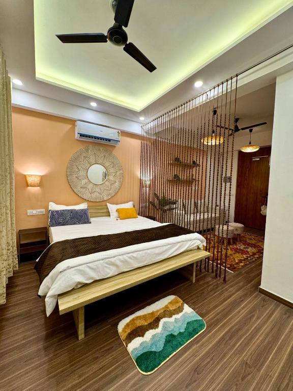 a bedroom with a large bed and a bathroom at Casa Musafir in Zirakpur
