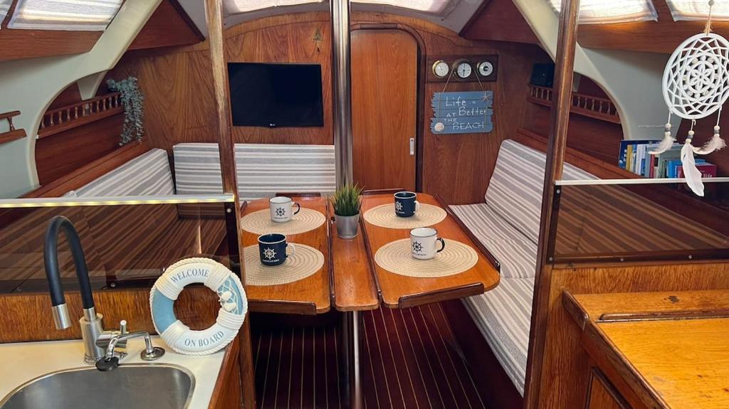 a kitchen with two tables in a boat at Unique Experience in Sailboat! In The 4 Seasons!! in Valencia