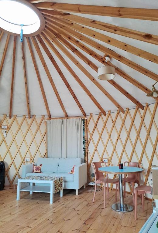 una habitación con sofá y mesa en una yurta en יורט 86 צוקים, en Tzukim