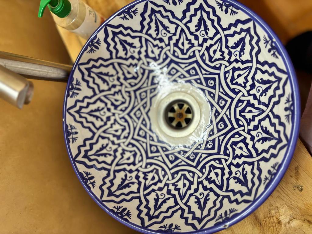 a blue and white plate with a pattern on it at Riad Ayoub Fes in Fès