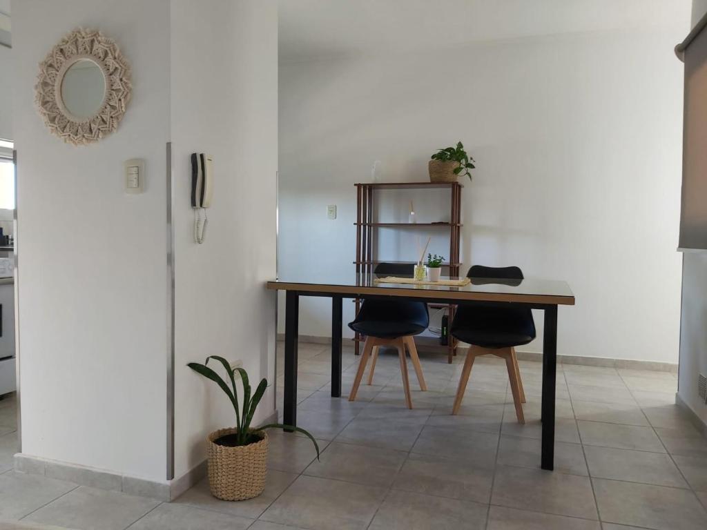 a dining room with a table and two chairs at Monoambiente Italia in Venado Tuerto