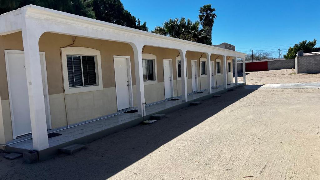 a row of white doors on a building at Cozy Rooms Near Beach Puerto Peñasco Rocky Point in Puerto Peñasco