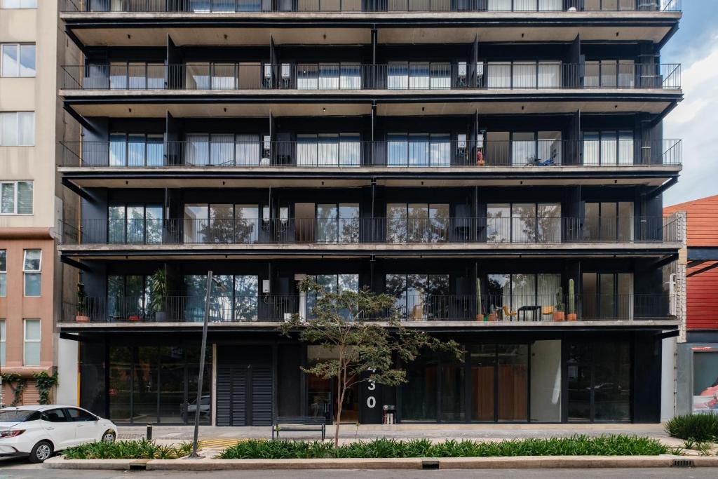 an apartment building with balconies in a city at Myla Chapultepec in Mexico City