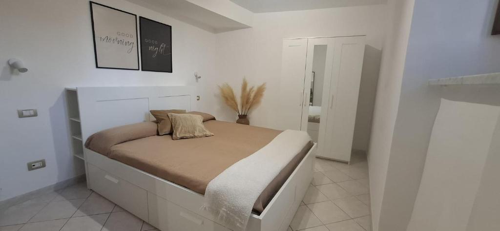 a bedroom with a bed in a white room at SoLe Apartment in Campagnano di Roma