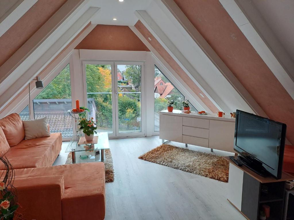 a living room with a couch and a tv at DESIGN-LOFT Brockenblick in Wernigerode
