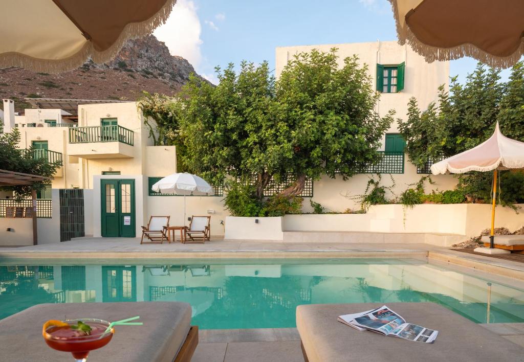 a pool in front of a building with a resort at Kalimera Village in Hersonissos