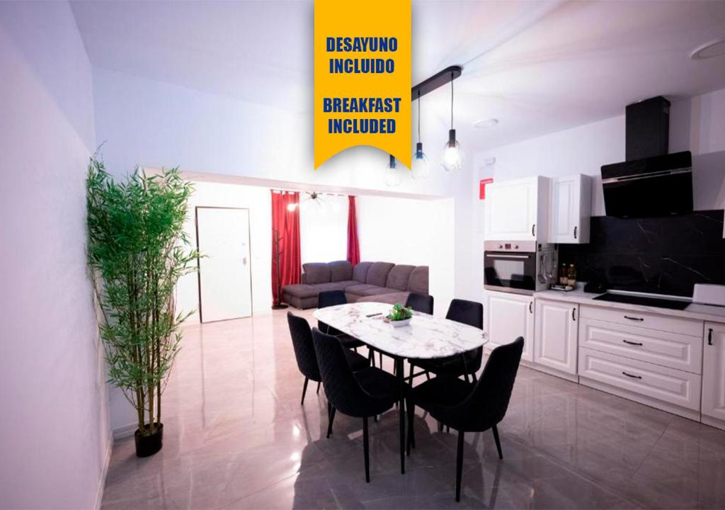 a kitchen and dining room with a table and chairs at Apartalux Premium Suites in Grao de Castellón