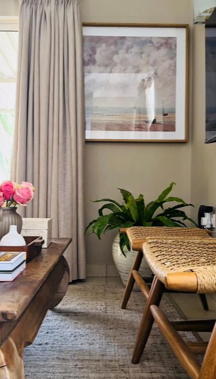 a living room with a bench and a table at The Loft Apartment in Gaborone in Gaborone