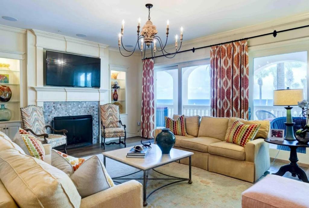a living room with couches and a fireplace at Resort-style Elegance in Blue Gulf Beach