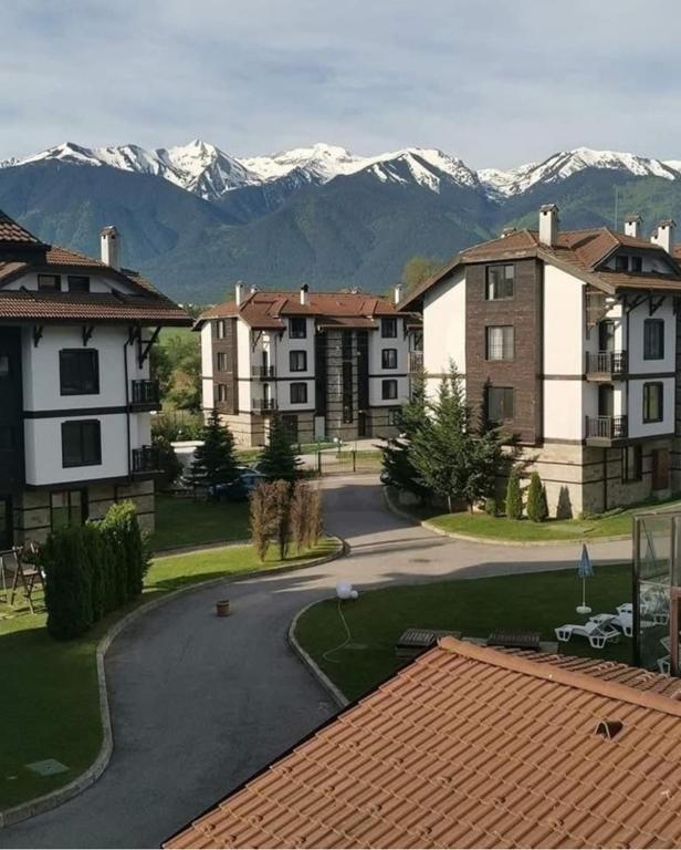 a street in a town with mountains in the background at ТРИ ПЛАНИНИ ап113 in Razlog