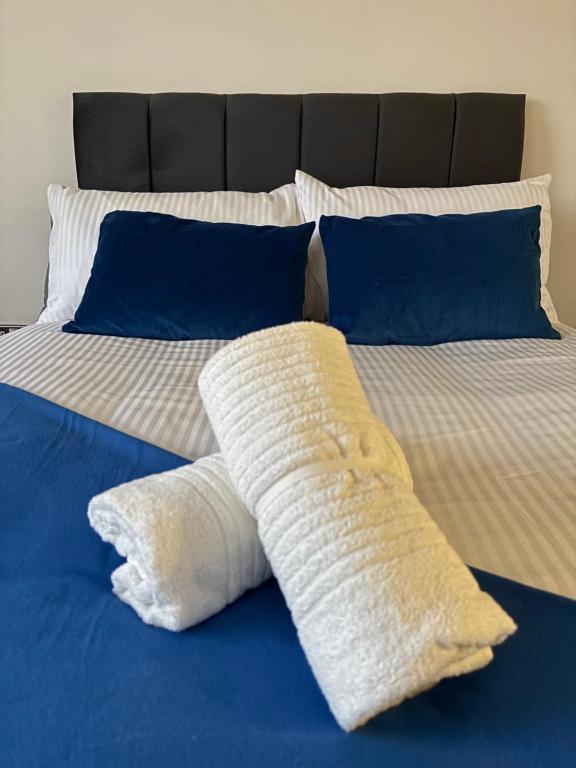 a bed with two pillows on top of it at Centrally located 1bed near Windsor Castle Slough in Slough