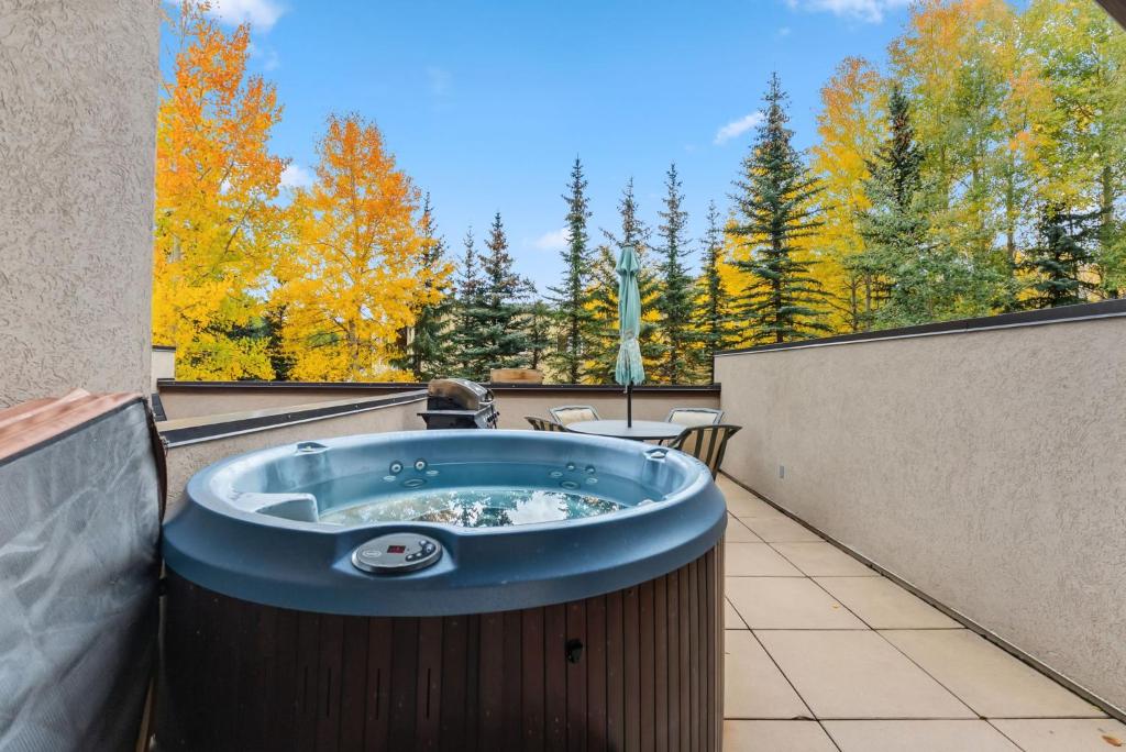 a jacuzzi tub on the balcony of a house at Cozy Breck Condo - Walk to Main St & Lifts - Hot Tub in Breckenridge