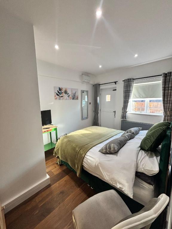 a bedroom with a large bed and a window at The Bungalow in Lichfield
