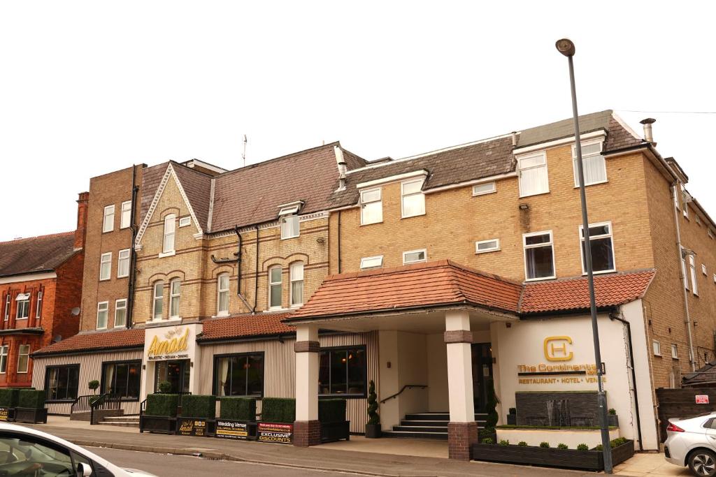 a large brick building on a city street at The Continental Hotel, Derby in Derby