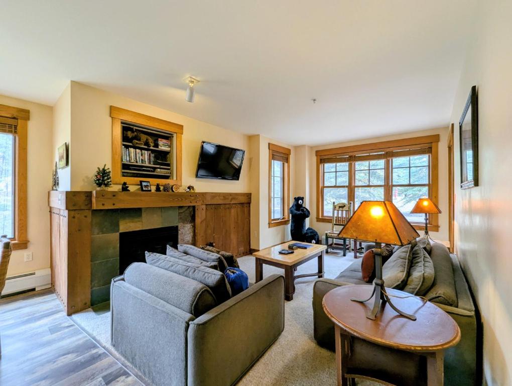 a living room with a couch and a fireplace at Springs 8803 by SummitCove Lodging in Colorado in Keystone