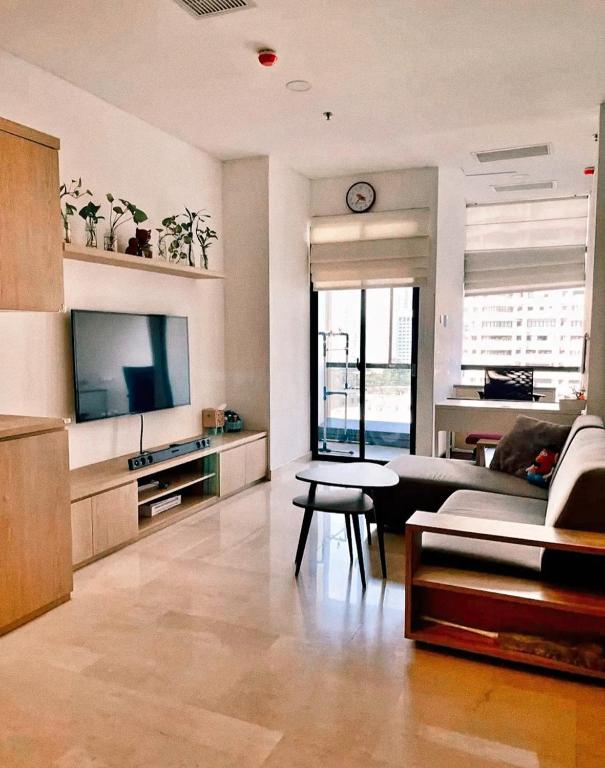 a living room with a couch and a tv at Indra Homs in Pabuaran Lima
