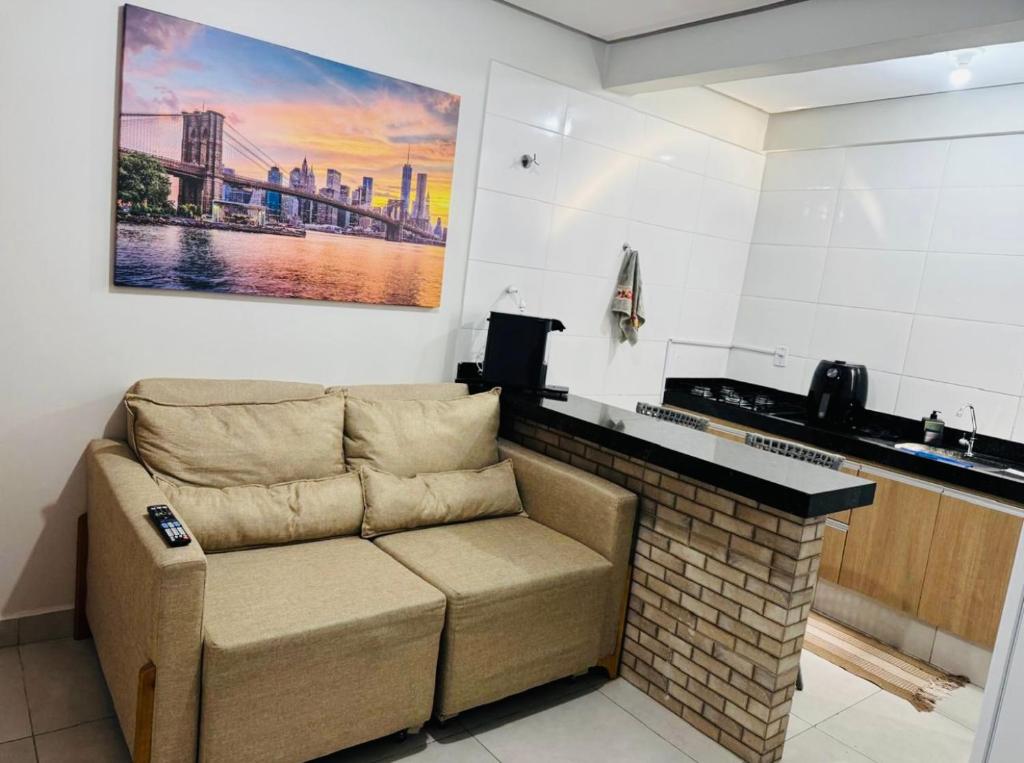a couch in a kitchen with a painting on the wall at Residencial Leste Universitário in Goiânia