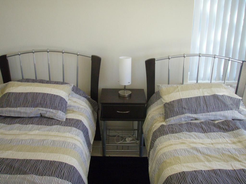 two beds sitting next to each other in a room at Unit 29 Ledge Point Village in Ledge Point