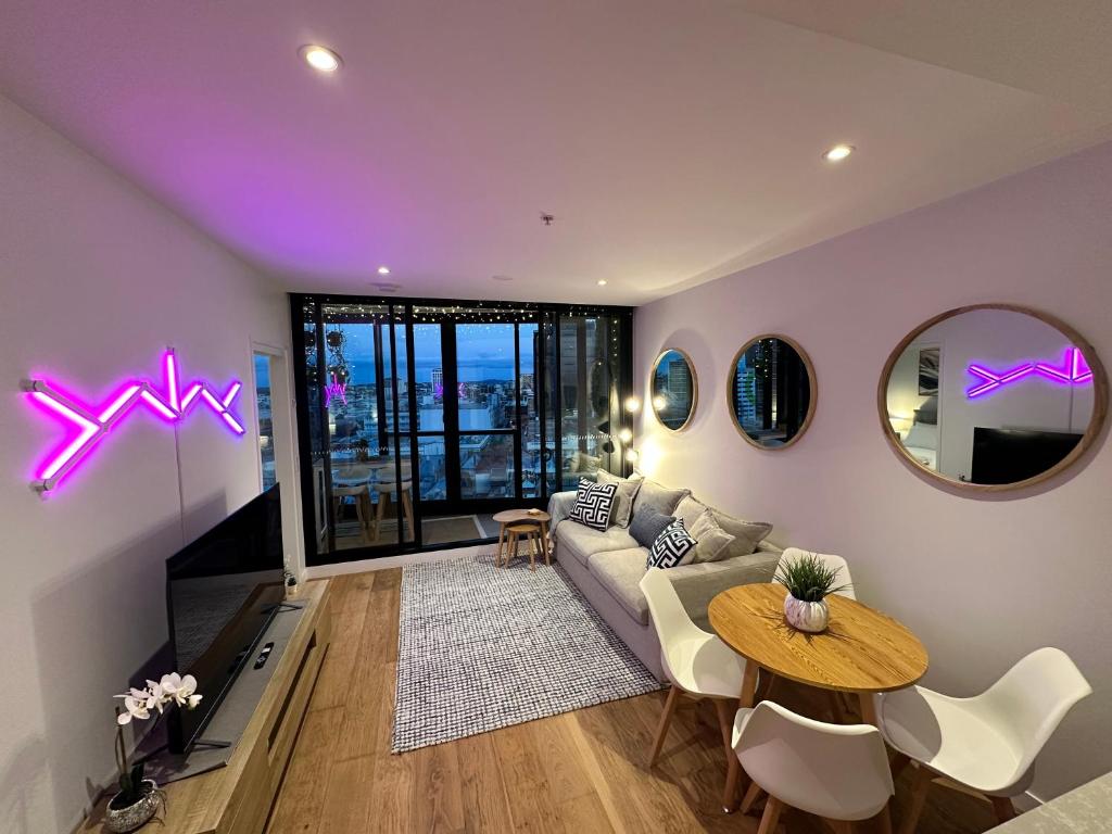 a living room with a couch and a table at Fortitude Valley Stylish Comfortable Apartment in Brisbane