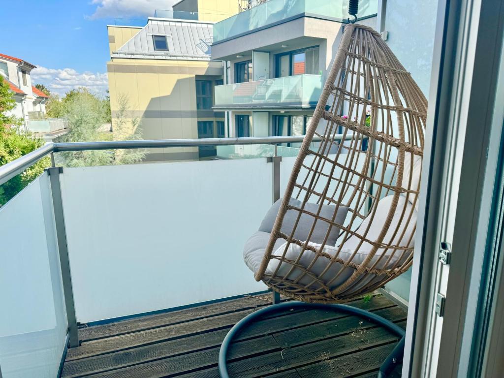 a hammock on a balcony with a view of a building at 140 m2 Spacious Apartment with Balcony & Parking in Vienna