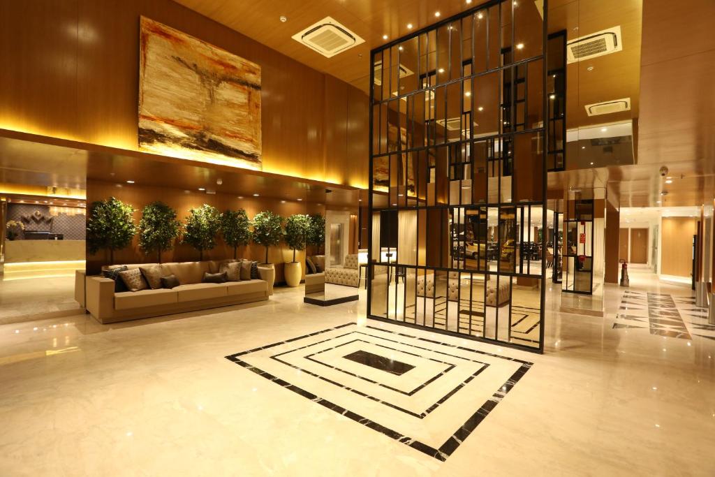 a lobby with a couch and a table in a building at Royal Regency Palace Hotel in Rio de Janeiro