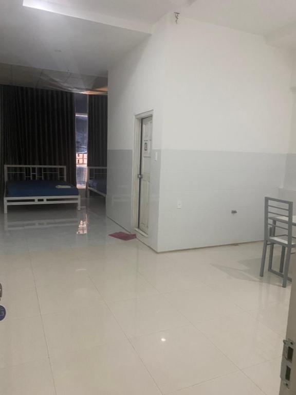an empty room with white walls and a table and chairs at Bình minh in Ấp Tân Ðiền (2)